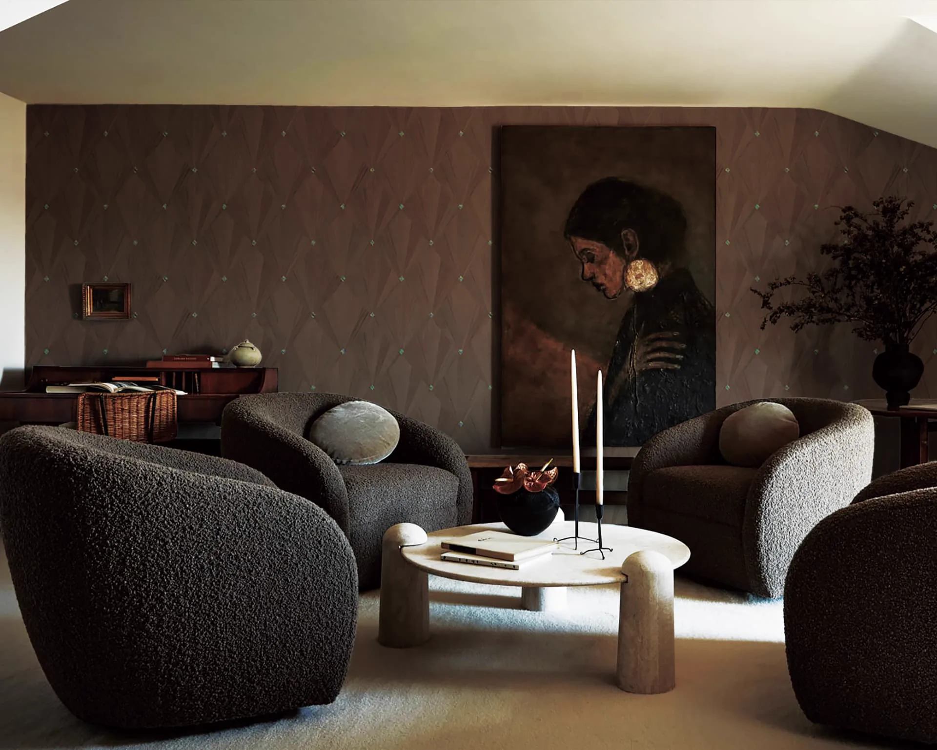 Lounge with a warm brown Architectural Collection wallcovering in a faceted diamond pattern with small turquoise accents, behind four bouclé armchairs and a large portrait painting